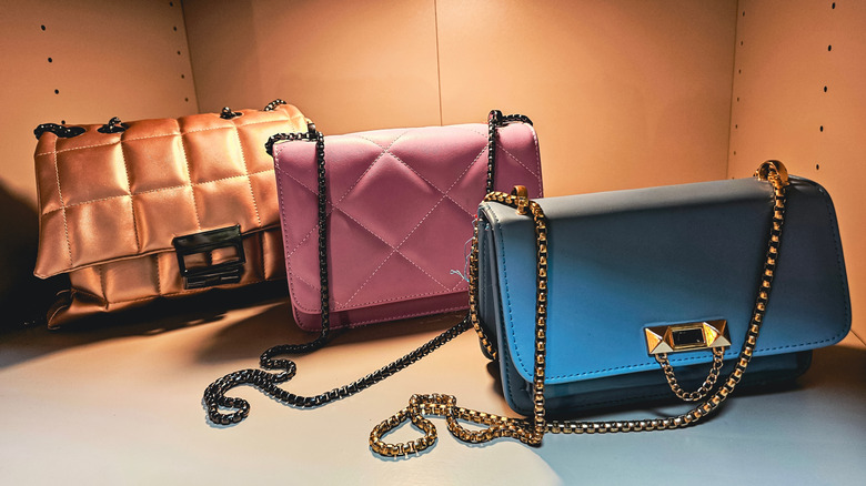 Pembe, mavi ve altın çantaları vurgulayan alt vuruş ışıkları