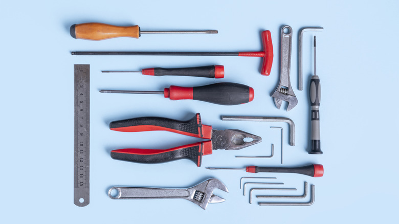 Mavi bir arka plan üzerine döşenen bir grup bireysel el aleti