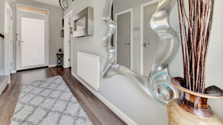 Bir parke zeminde koşucu halısı olan giriş yolu