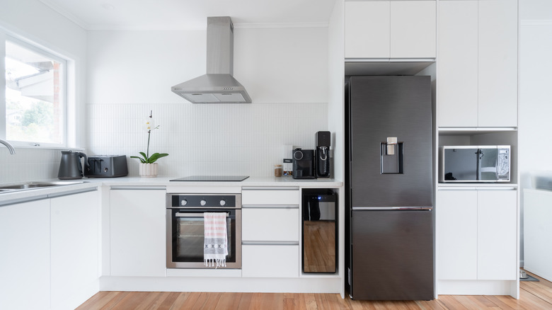 Buzdolabının üstünde dolaplı monokromatik mutfak