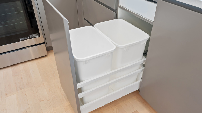 Gümüş dolapta iki beyaz çöp kutusu