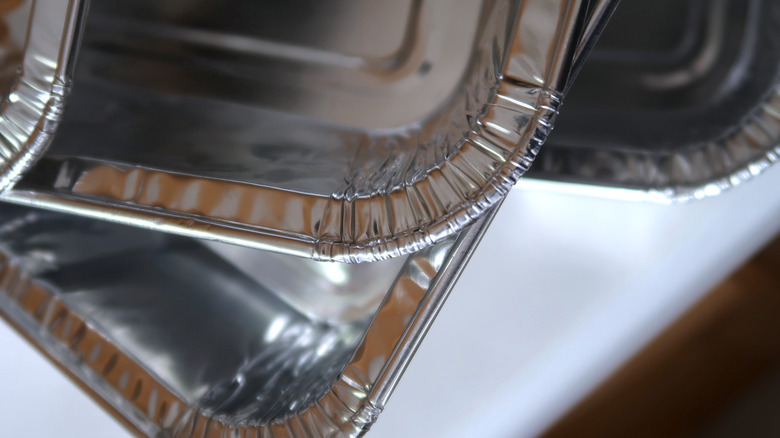 Bir tezgahın üstüne yığılmış birkaç folyo tava