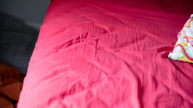 Pembe çarşaf getiren bir yatak