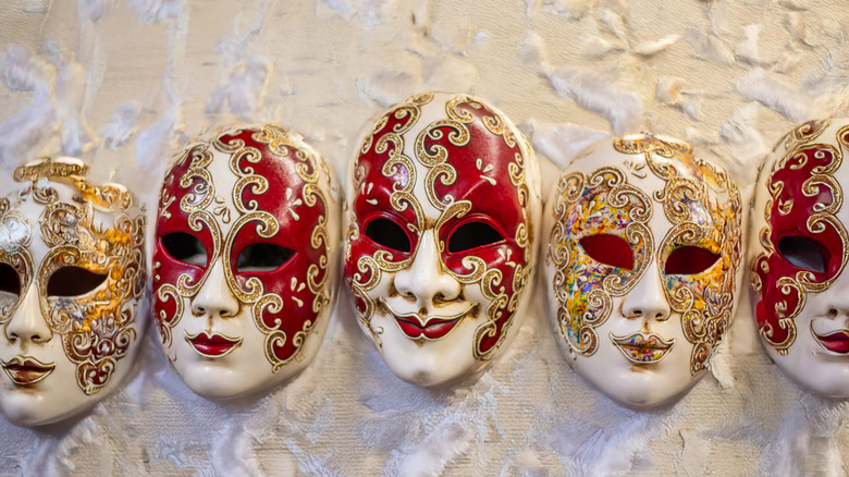 Zarif altın, kırmızı ve beyaz Venedik maskeleri.