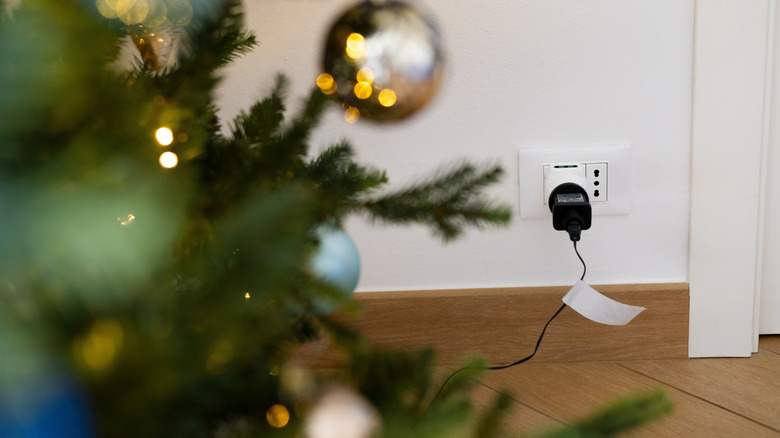 Duvara ışıkları takılı Noel ağacı.