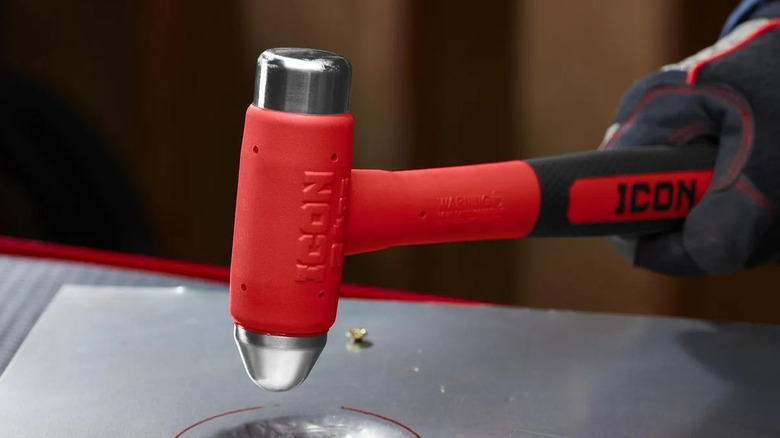 Bir kişi, bir metal parçası üzerinde Icon 24 onsluk bilyalı çekiç kullanıyor