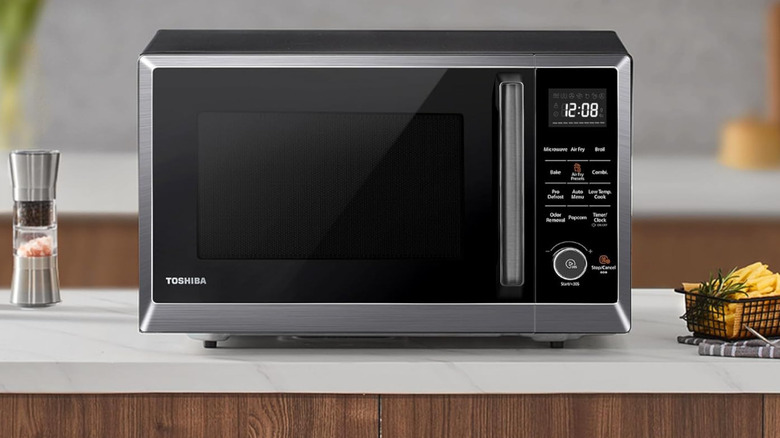 Beyaz tezgah üzerinde Toshiba 8'i 1 arada mikrodalga fırın.