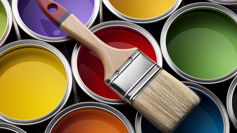 bir boya fırçası ile renkli boya kutuları