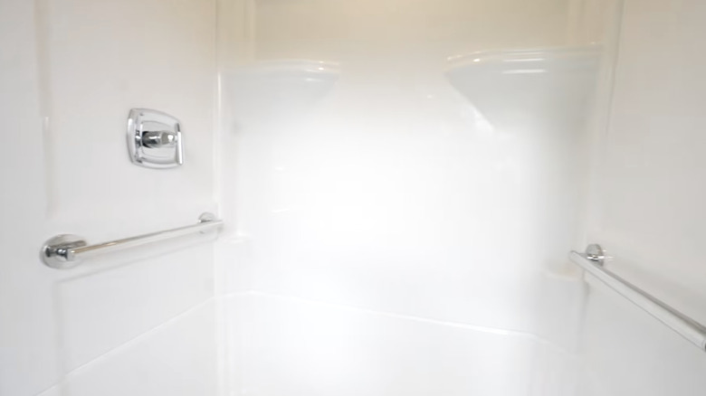 Cam elyafından yapılmış ve gümüş armatürler içeren bir duş