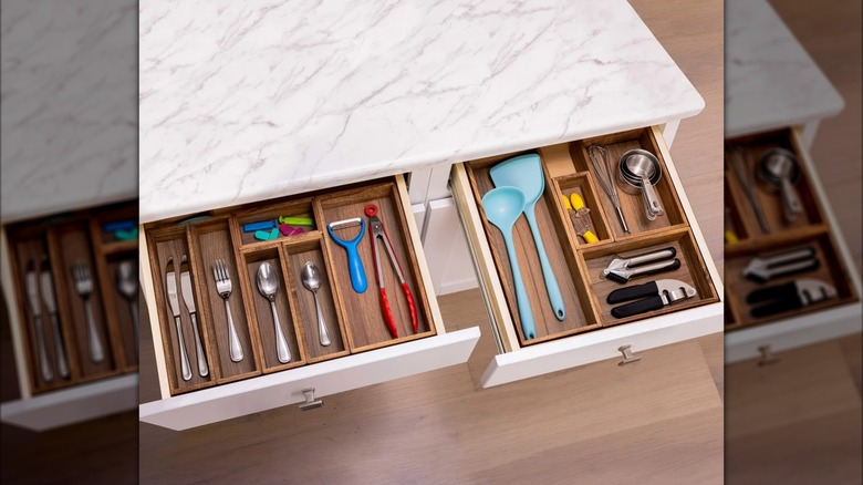 Çeşitli sofra takımlarını ve mutfak aletlerini saklayan ahşap çekmece düzenleyicileri