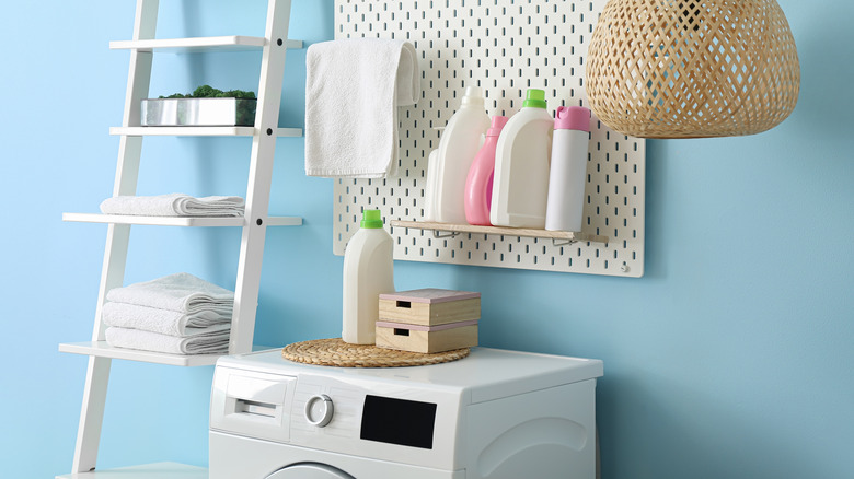 Pegboard ve merdiven saklama yeri olan bir çamaşır odası