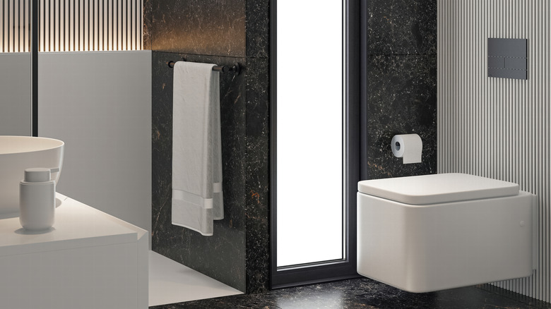 Duşu duvarla kapatılmış ve bol miktarda aydınlatma bulunan yüzen kare tuvalet