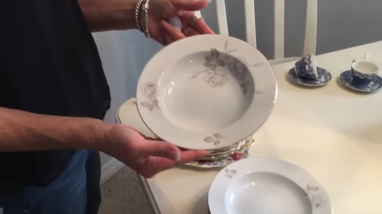 Masada bir parça kemik çini tutan kadının eli