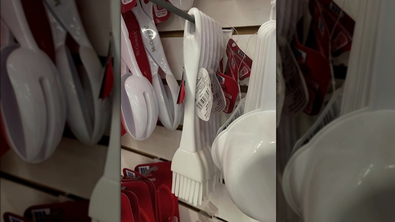 Dollar Tree'nin duvarında asılı duran beyaz bir McCormick silikon teyel fırçası.