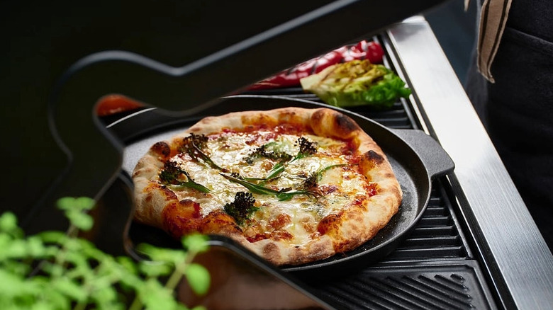 Izgarada pişirilen pizza tavasındaki pizza
