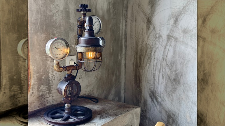 Tellerden ve borulardan yapılmış steampunk tarzı bir masa lambası.